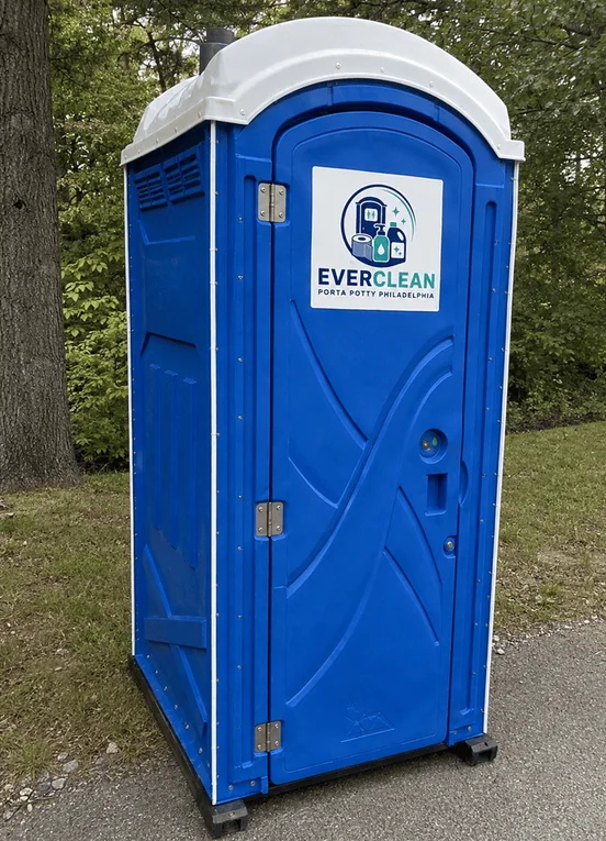 Blue standard porta potty unit on grass