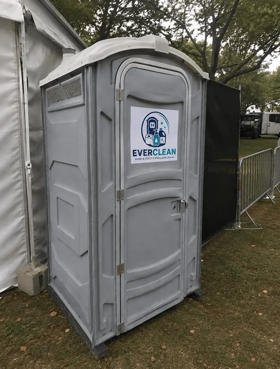 Everclean Porta Potty Philadelphia unit set up beside a marquee at an outdoor event